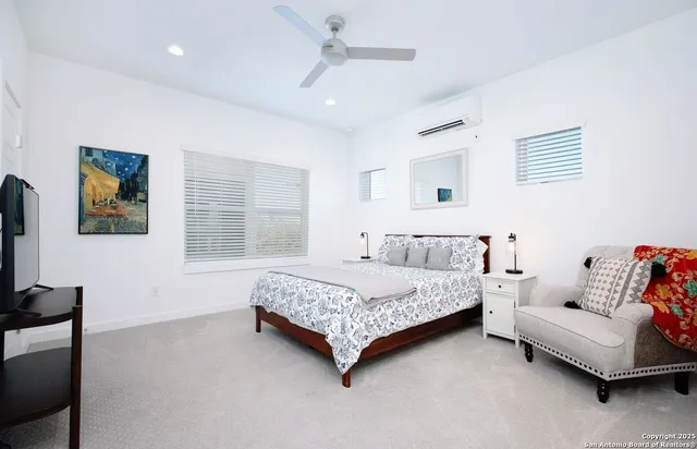 a bedroom with a bed and a couch