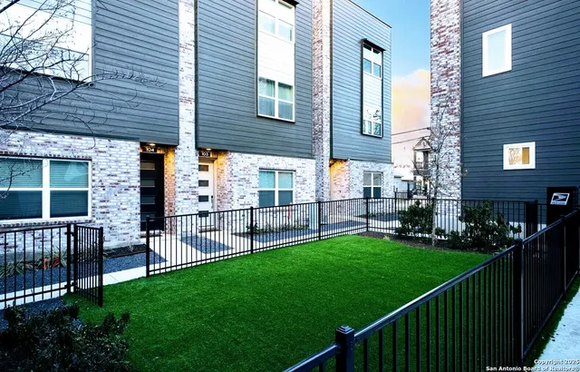 a view of a porch with chairs and wooden fence