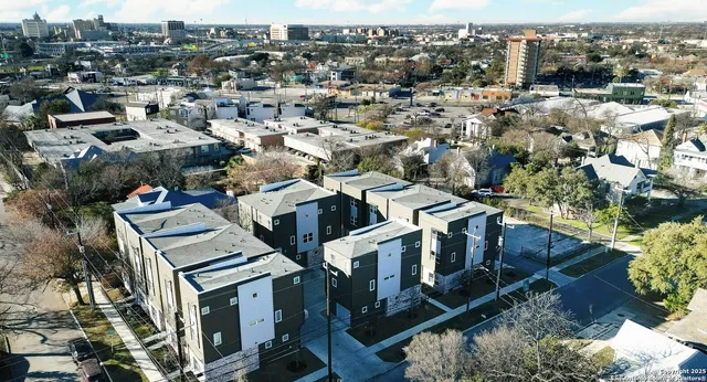 an aerial view of a residential apartment building with a yard
