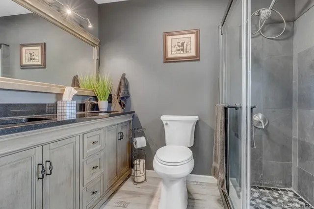 a bathroom with a toilet sink and shower