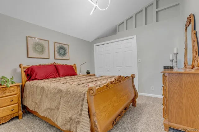 a bedroom with bed and cabinet