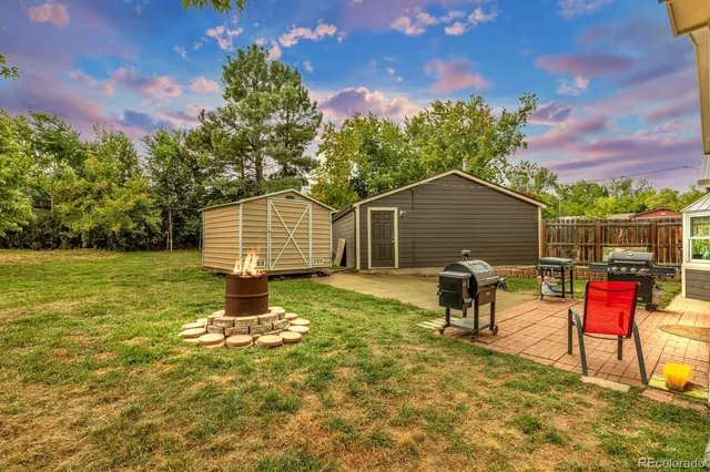 a backyard of a house with table and chairs