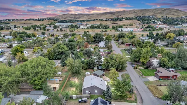 an aerial view of residential houses with outdoor space and trees