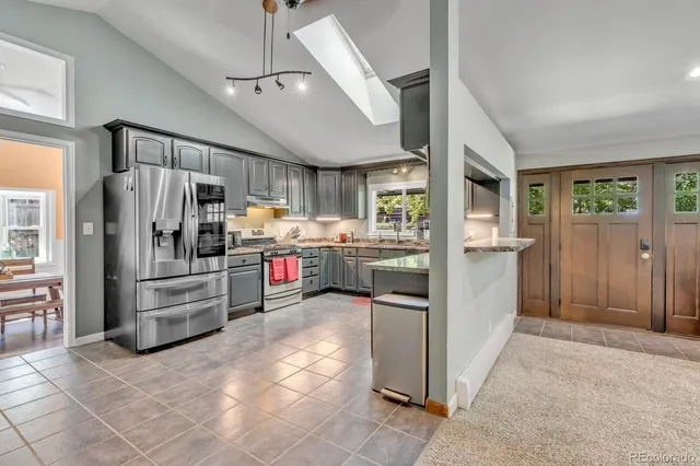 a kitchen with stainless steel appliances a refrigerator and a stove