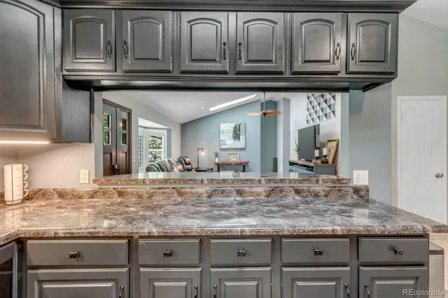 a kitchen with kitchen island granite countertop stainless steel appliances and cabinets