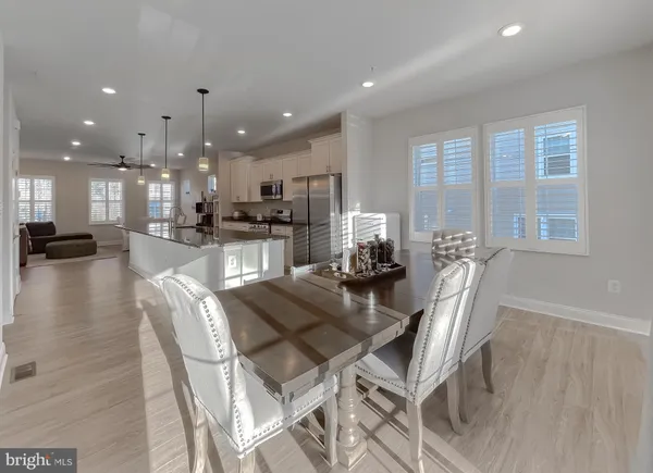 a dining room with furniture and a wooden floor