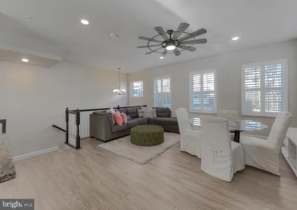 a living room with furniture and a large mirror