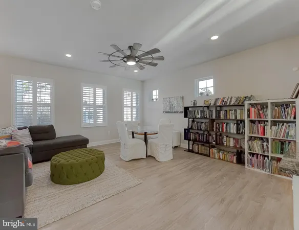 a living room with furniture and a book shelf