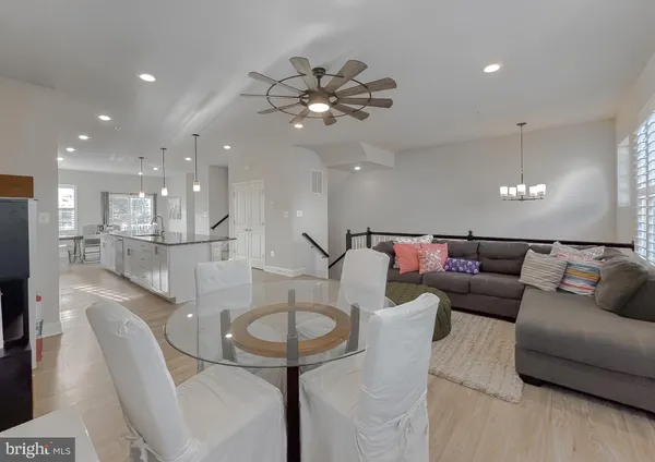 a living room with furniture and a view of kitchen