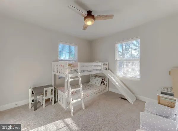 a spacious bedroom with a bed and a chandelier