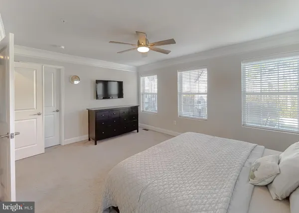 a spacious bedroom with a bed and a large window