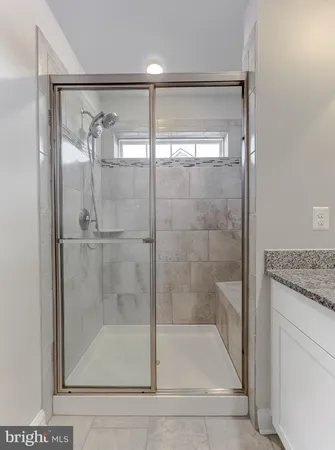 a bathroom with a glass shower door