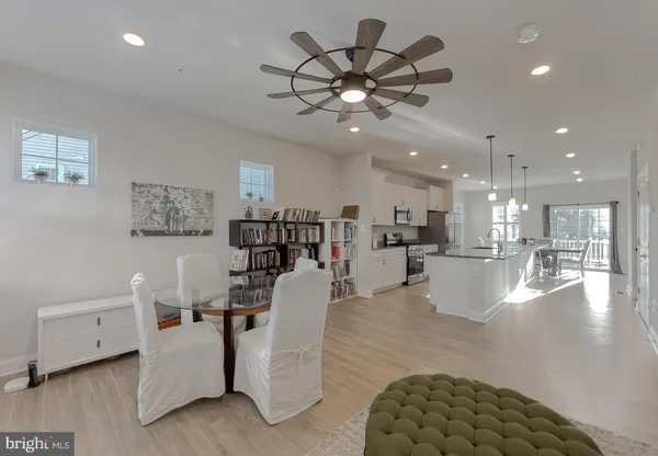 a living room with furniture and kitchen view