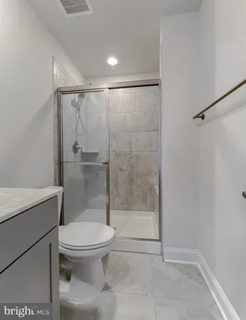 a bathroom with a toilet and a shower