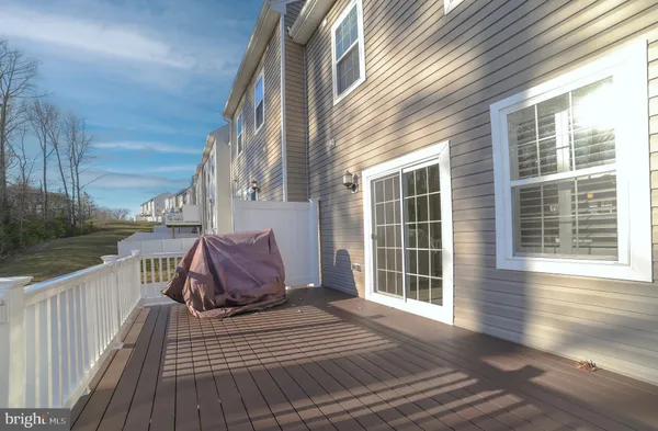 a view of a deck with wooden floor and fence