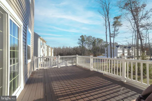 a balcony with wooden floor and fence