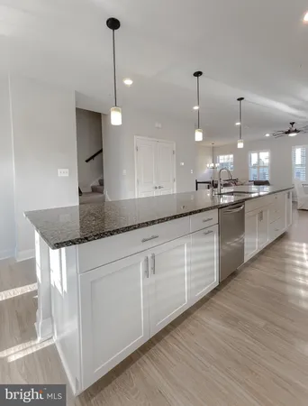 a kitchen with stainless steel appliances granite countertop a sink a stove a refrigerator and a granite counter tops