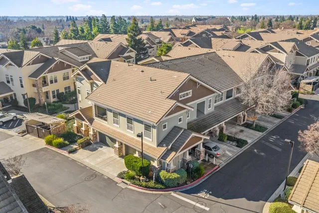 a living room with furniture a flat screen tv and a potted plant