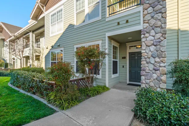 a living room with furniture a large window and a flat screen tv
