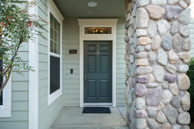 a kitchen with stainless steel appliances granite countertop a stove a sink a refrigerator and a granite counter tops with white cabinets