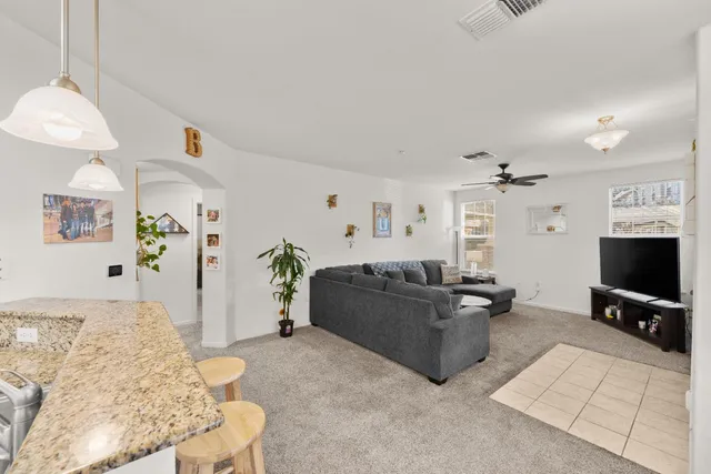 a kitchen with stainless steel appliances a refrigerator a sink a stove a dining table and chairs