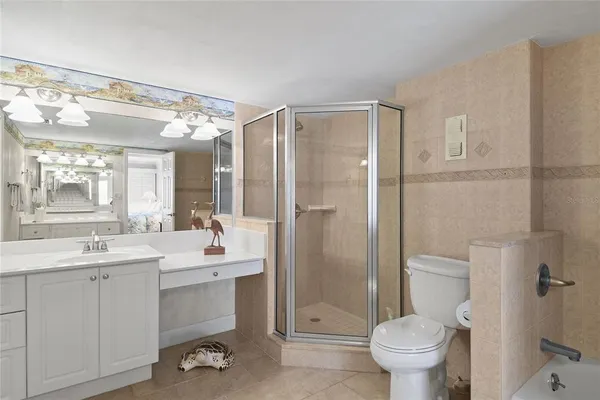 a bathroom with a double vanity sink mirror and bathtub