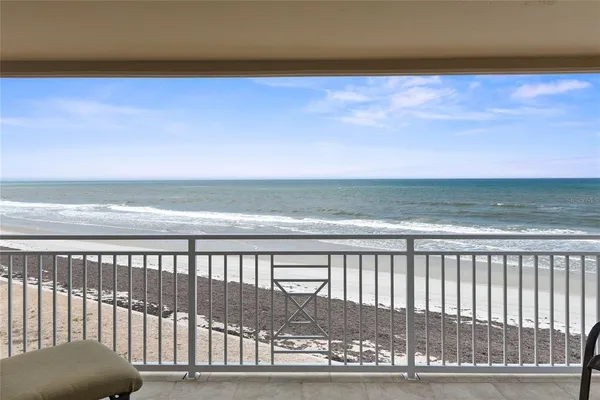 a view of a living room and a floor to ceiling window