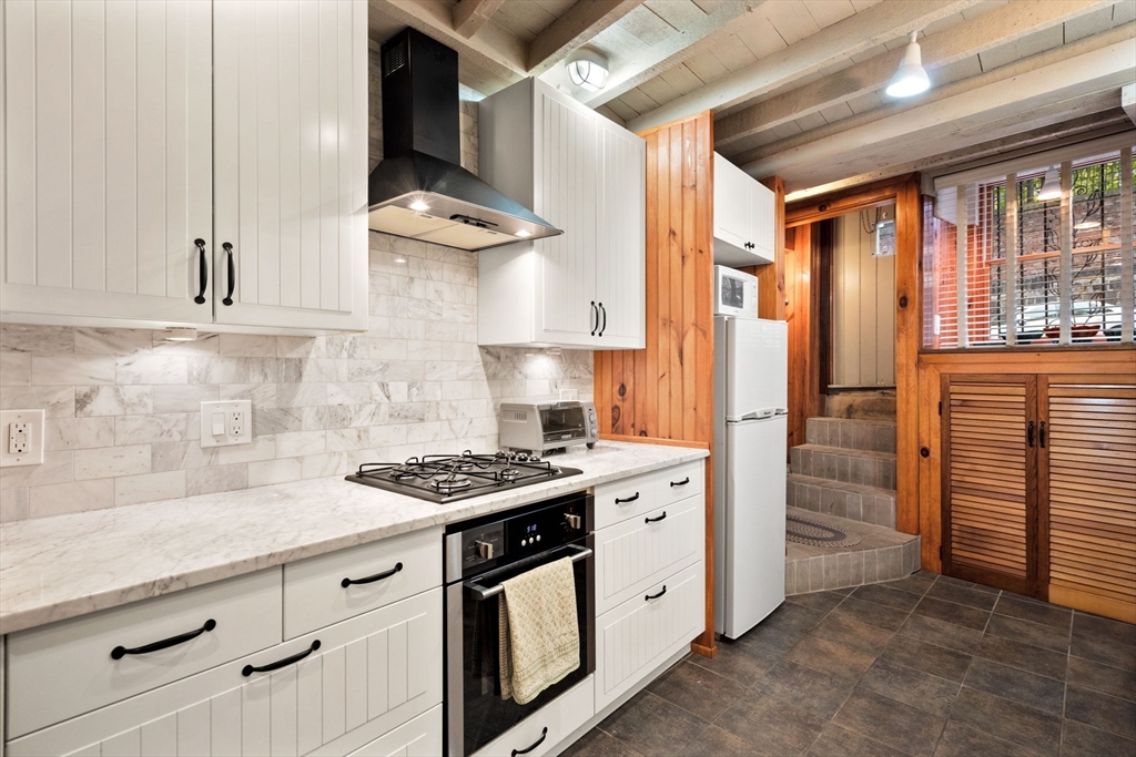 a kitchen with stainless steel appliances granite countertop a stove and a sink