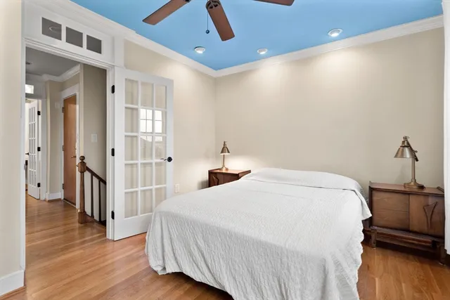 a bedroom with a bed and wooden floor
