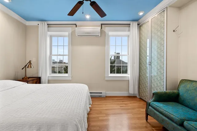 a bedroom with a bed couch and window