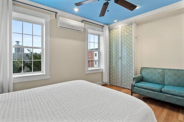 a bedroom with furniture and a window