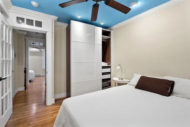 a bedroom with a bed and a view of kitchen