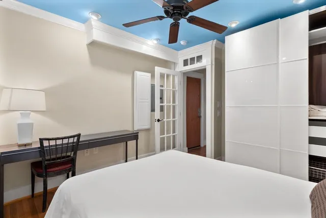 a bedroom with a bed and a lamp on a table