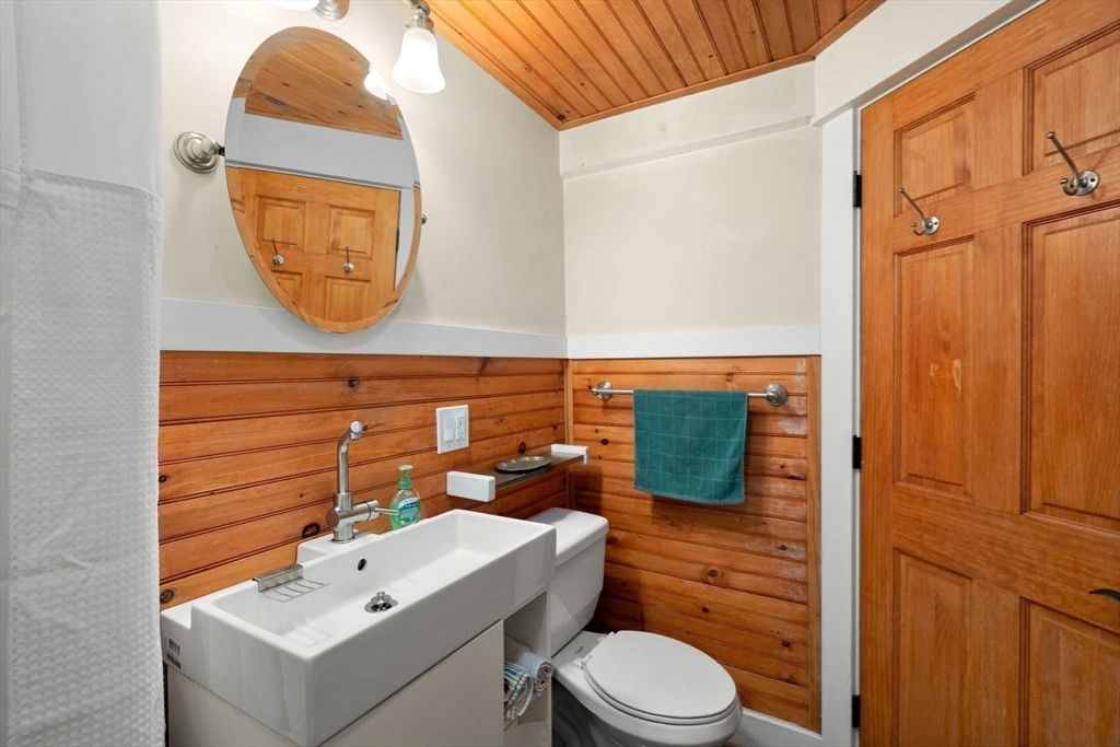 6 North Hudson Street, Unit 1 Boston, MA 02113 - Photo 17 of 22 a bathroom with a sink mirror vanity and toilet