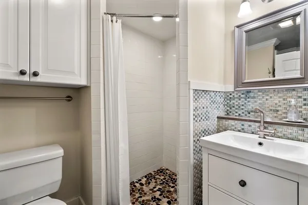 a bathroom with a sink toilet and shower