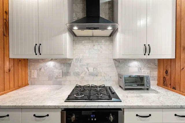 a kitchen with granite countertop a stove and a sink