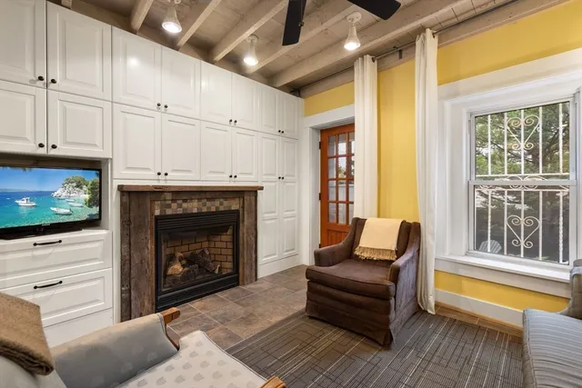 a living room with furniture a flat screen tv and a fireplace