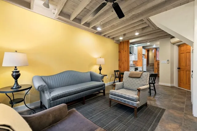 a living room with furniture and a rug