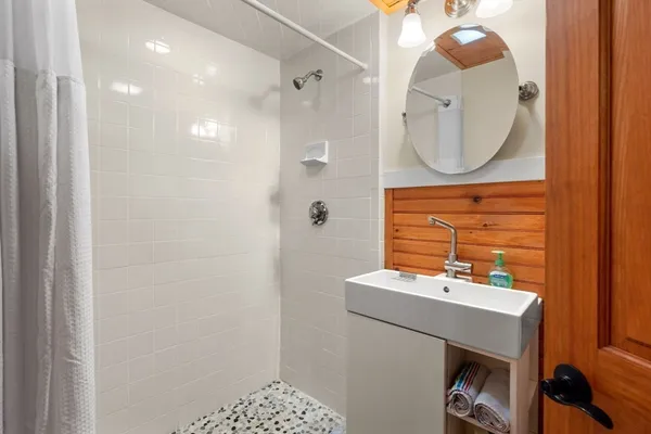 a bathroom with a sink a mirror and a vanity