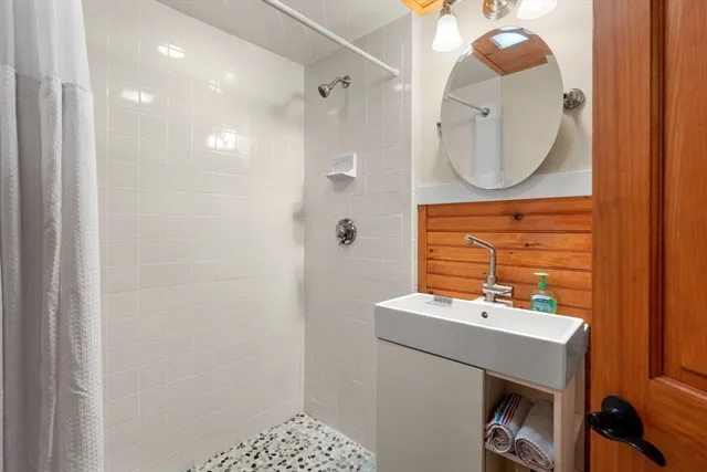 a bathroom with a sink a mirror and a vanity