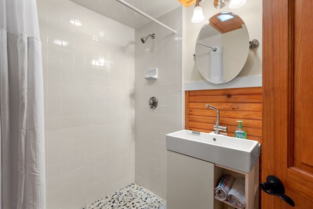 6 North Hudson Street, Unit 1 Boston, MA 02113 - Photo 10 of 22 a bathroom with a sink a mirror and a vanity