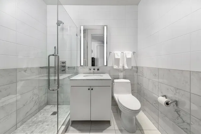 a bathroom with a toilet sink and shower