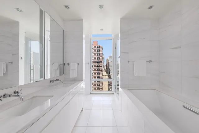 a bathroom with a tub sink and a mirror
