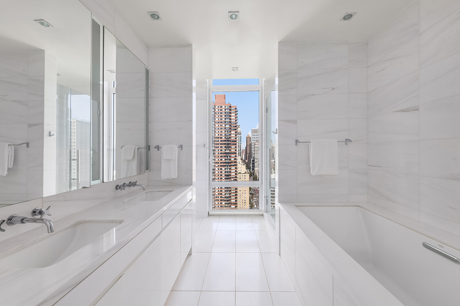 1355 1st Avenue, Unit 22 Manhattan, NY 10021 - Photo 8 of 16 a bathroom with a tub sink and a mirror