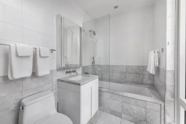 a bathroom with a sink toilet and shower