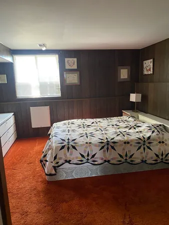 a living room with furniture a window and a flat screen tv