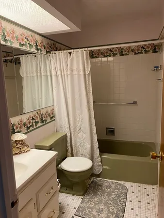a bathroom with a toilet and a shower