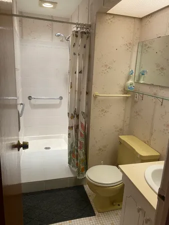 a bathroom with a toilet and a shower