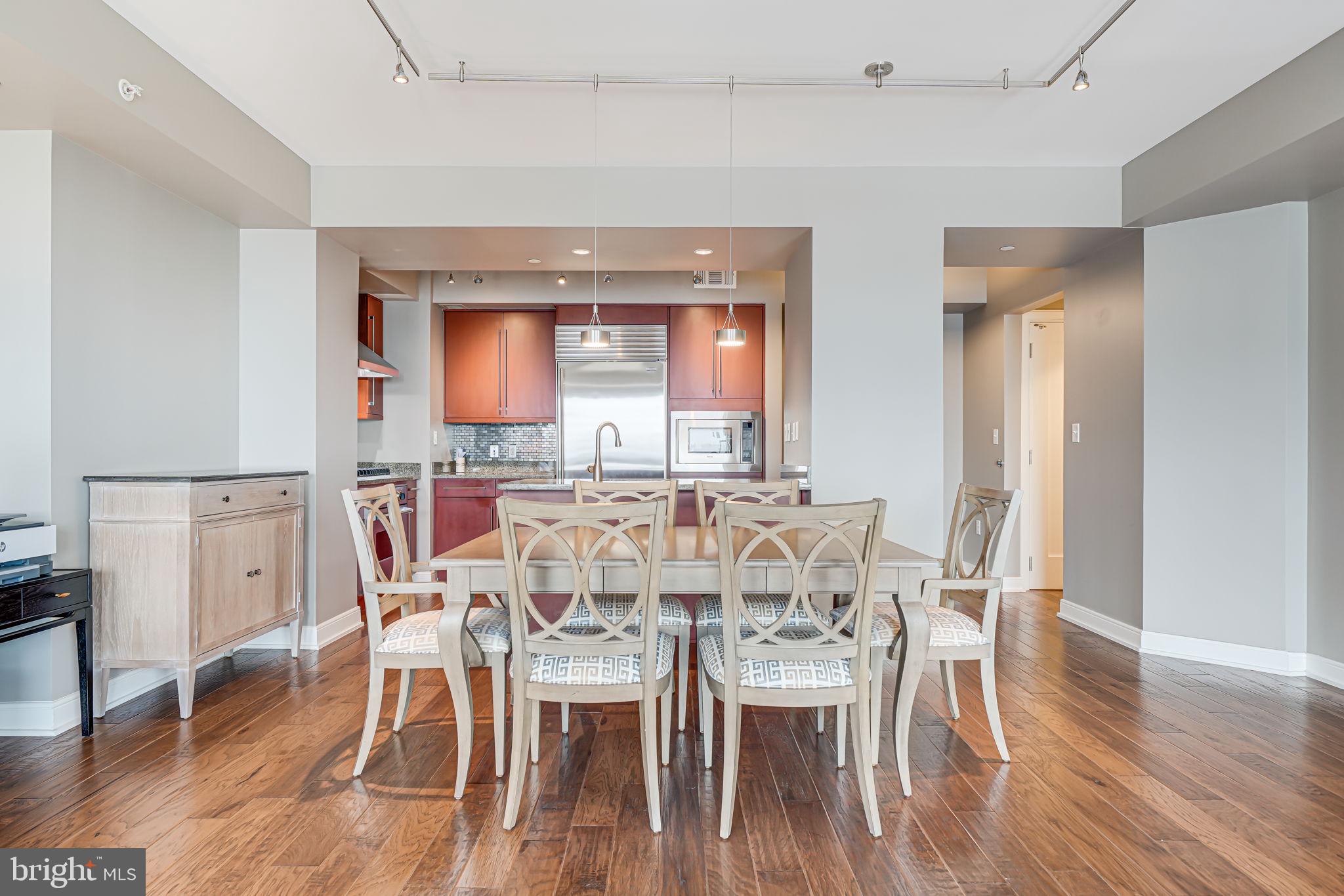 1111 19th Street North, Unit 2703 Arlington, VA 22209 - Photo 14 of 52 a view of a dining room with furniture and wooden floor