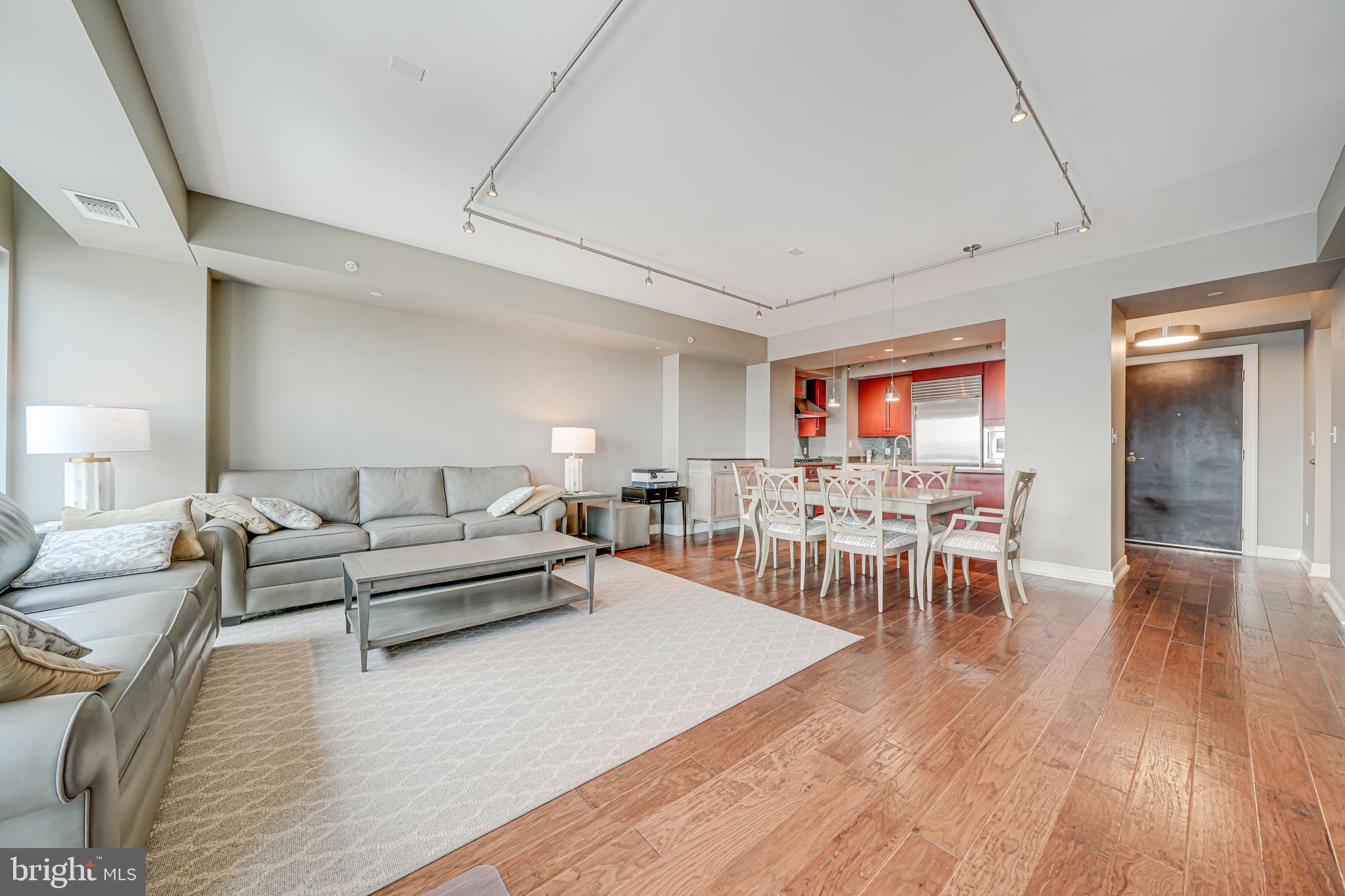 1111 19th Street North, Unit 2703 Arlington, VA 22209 - Photo 21 of 52 a living room with furniture and a wooden floor